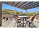 Outdoor patio with pergola and seating for dining and relaxing at 18961 N 264Th Ave, Buckeye, AZ 85396