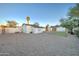 A gravel backyard featuring a grassy patch, storage shed, a block wall, and a palm tree at 1934 E Brill St, Phoenix, AZ 85006