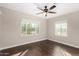 Cozy bedroom with hardwood floors, a ceiling fan, and two windows offering ample natural light at 1934 E Brill St, Phoenix, AZ 85006