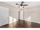 Bright bedroom featuring hardwood floors, ceiling fan, and two entry doors at 1934 E Brill St, Phoenix, AZ 85006