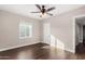 Well-lit bedroom with hardwood floors, ceiling fan, and a window providing natural light at 1934 E Brill St, Phoenix, AZ 85006