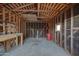 Interior unfinished room with wood framing, concrete floor, and a small window at 1934 E Brill St, Phoenix, AZ 85006