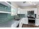 Well-lit kitchen featuring modern appliances, ample counter space, and beautiful tile backsplash at 1934 E Brill St, Phoenix, AZ 85006