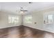 Sunlit living room boasts wood floors, fresh paint, large windows and ceiling fan at 1934 E Brill St, Phoenix, AZ 85006