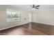 Bright living room with beautiful wood floors, large window, and ceiling fan at 1934 E Brill St, Phoenix, AZ 85006