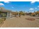 Spacious backyard with patio cover, gravel, and mature landscaping at 19611 N Stardust Blvd, Sun City West, AZ 85375