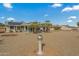 Backyard view with gravel, mature palm trees, and a large yard at 19611 N Stardust Blvd, Sun City West, AZ 85375