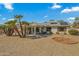 Sun-drenched backyard with gravel, patio cover, and solar panels at 19611 N Stardust Blvd, Sun City West, AZ 85375