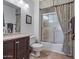 Clean bathroom with shower/tub combo, vanity, and decorative curtains at 19611 N Stardust Blvd, Sun City West, AZ 85375