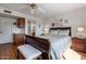 Main bedroom with a sleigh bed, wood floors, and ensuite bathroom access at 19611 N Stardust Blvd, Sun City West, AZ 85375