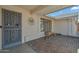 Decorative iron door leading to a brick paved entryway with a bench at 19611 N Stardust Blvd, Sun City West, AZ 85375