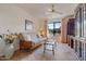 Cozy office featuring a futon, built-in shelving, and large window at 19611 N Stardust Blvd, Sun City West, AZ 85375