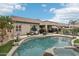 Backyard featuring a pool with rock detail, covered patio, and manicured landscaping at 20490 N 78Th Way, Scottsdale, AZ 85255