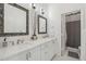 Bright bathroom featuring double sinks, decorative mirrors, and modern fixtures at 20490 N 78Th Way, Scottsdale, AZ 85255