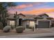 Charming single-story home featuring desert landscaping and a tile roof set against a vibrant sunset sky at 20490 N 78Th Way, Scottsdale, AZ 85255