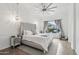 Bright main bedroom with a tufted headboard, wood floors, a ceiling fan, and a view of the backyard at 20490 N 78Th Way, Scottsdale, AZ 85255