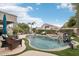 Backyard pool with rock features, landscaping, and outdoor seating area at 20490 N 78Th Way, Scottsdale, AZ 85255