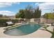 Backyard pool with a waterfall feature, lush landscaping, and a basketball hoop at 20490 N 78Th Way, Scottsdale, AZ 85255