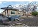 Backyard hot tub with patio umbrella and landscaping at 21004 E Sunset Dr, Queen Creek, AZ 85142