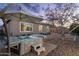 Spacious hot tub with steps and patio umbrella in backyard at 21004 E Sunset Dr, Queen Creek, AZ 85142