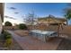 Relaxing hot tub on a brick patio under an umbrella at 21004 E Sunset Dr, Queen Creek, AZ 85142