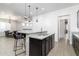 Kitchen island with seating and stainless steel appliances at 21004 E Sunset Dr, Queen Creek, AZ 85142