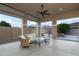 Covered patio with wicker furniture and ceiling fan at 21004 E Sunset Dr, Queen Creek, AZ 85142