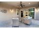 Covered patio with wicker seating and a view into the home at 21004 E Sunset Dr, Queen Creek, AZ 85142