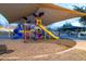 Community playground with play structures, shaded area, and picnic tables at 21004 E Sunset Dr, Queen Creek, AZ 85142