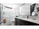 Modern bathroom with white tile, a large mirror, and dark vanity at 23776 N 167Th Ln, Surprise, AZ 85387