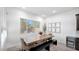 Light and airy dining area with wooden table and bench seating at 23776 N 167Th Ln, Surprise, AZ 85387