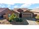 Single-story home with two-car garage and desert landscaping at 23776 N 167Th Ln, Surprise, AZ 85387