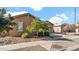 Tan house with a two-car garage and drought-tolerant landscaping at 23776 N 167Th Ln, Surprise, AZ 85387