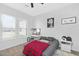 Bright bedroom with a vanity, shutters on the windows, and a red plaid blanket on the bed at 24540 S 190Th Ct, Queen Creek, AZ 85142