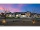 Exterior view of luxury home at dusk featuring manicured landscaping and long stone driveway at 24540 S 190Th Ct, Queen Creek, AZ 85142