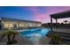 Backyard view featuring a pool with a spa and a covered patio at dusk at 24540 S 190Th Ct, Queen Creek, AZ 85142