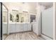 Bathroom with walk-in shower, double vanity, and modern fixtures at 25740 W Watkins St, Buckeye, AZ 85326