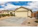 Tan house with a two-car garage and landscaped yard at 25740 W Watkins St, Buckeye, AZ 85326