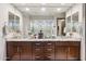 Double vanity bathroom with granite countertops and large mirrors at 26019 W Ponderosa Ln, Buckeye, AZ 85396