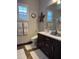 Bathroom with double vanity, dark brown cabinets and modern toilet at 26019 W Ponderosa Ln, Buckeye, AZ 85396