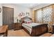 Charming bedroom with a double bed, ornate furniture, and a window at 26019 W Ponderosa Ln, Buckeye, AZ 85396