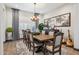 Bright dining room with a large wood table and chandelier at 26019 W Ponderosa Ln, Buckeye, AZ 85396