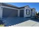 Single-story home with gray garage door and stone accents at 26019 W Ponderosa Ln, Buckeye, AZ 85396