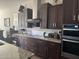 Modern kitchen with dark cabinetry and granite countertops at 26019 W Ponderosa Ln, Buckeye, AZ 85396