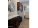 Laundry room with washer, dryer, and dark wood cabinets at 26019 W Ponderosa Ln, Buckeye, AZ 85396