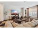 Relaxing living room, featuring comfortable sofas and a large TV at 26019 W Ponderosa Ln, Buckeye, AZ 85396