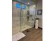 Large walk-in shower with marble tile and built-in shelving at 26019 W Ponderosa Ln, Buckeye, AZ 85396