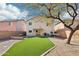 Spacious backyard with artificial turf, patio, and hammock at 28125 N Silver Ln, San Tan Valley, AZ 85143