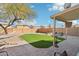 Backyard with artificial turf, covered patio, and hammock at 28125 N Silver Ln, San Tan Valley, AZ 85143