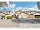 Two-story house with a beige exterior, two-car garage, and landscaped front yard at 28125 N Silver Ln, San Tan Valley, AZ 85143